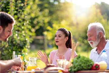 Family having lunch at summer garden party