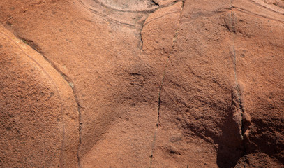 Fototapeta premium red sandstone background with curious abstract shapes