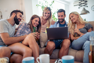 Friends watching football game on laptop