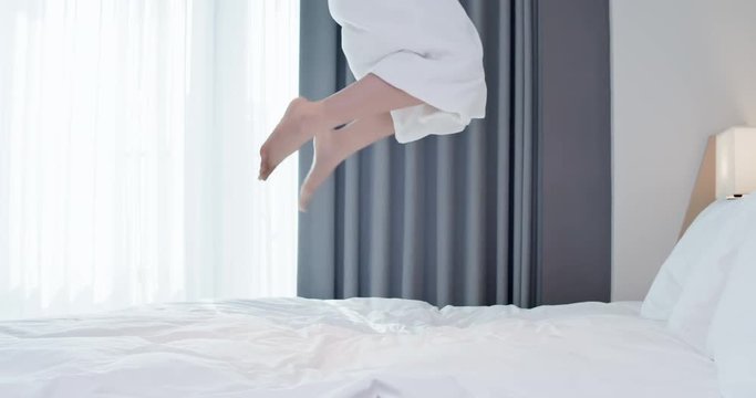 Excited woman jump with bathrobe