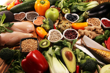 Healthy food clean eating selection. fruit, vegetable, seeds, superfood, cereals, leaf vegetable on rustic background