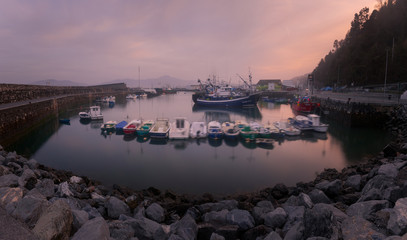 Fototapeta premium Seaport from Hondarribia at golden hour with fullmoon, at the Basque Country.