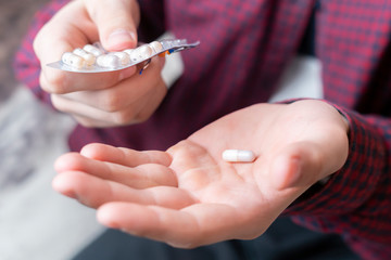 persons hands take white pill  b