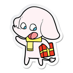 sticker of a cute cartoon elephant with christmas present