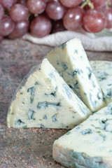 Fourme Ambert semi-hard French blue cheese made from raw cow milk served as dessert with grapes