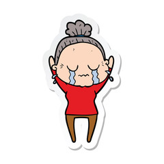sticker of a cartoon old woman crying
