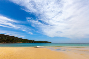 Turquoise ocean water and yellow sand  at Fingal Bay, New South Wales, Australia