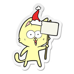 funny sticker cartoon of a cat with sign wearing santa hat