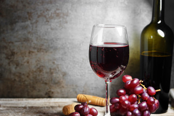 Red Wine Glass And Bottle On Wooden Table