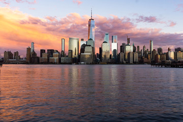 Fototapeta na wymiar Sunset view of Lower Manhattan with reflections in the Hudson River