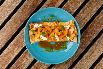 Sweet blini with pineapple and sauce