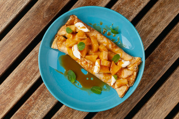 Sweet blini with pineapple and sauce