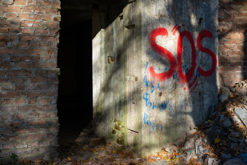 Abandoned building with an inscription SOS