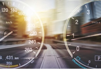 Speedometers on road background with blue cloudy sky