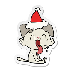 sticker cartoon of a panting dog wearing santa hat