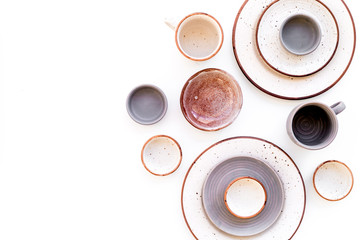 Ceramic tableware pattern. Empty plates and mugs on white background top view copy space