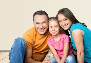 Fototapeta premium Beautiful smiling family sitting at sofa at home