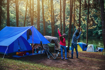 Asian woman travel nature camping on the Mountain see the lake in the mist at morning sunrise at Pang Ung , Mae Hong Son province, Thailand.