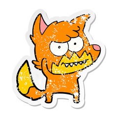 distressed sticker of a cartoon grinning fox
