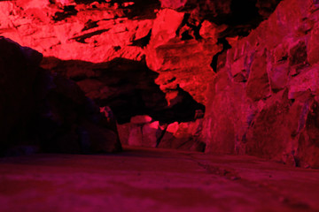 Karst cave in variety of colored light.