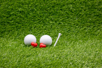 To golfer with love with two balls and tow hearts
