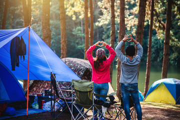 Asian woman travel nature camping on the Mountain see the lake in the mist at morning sunrise at Pang Ung , Mae Hong Son province, Thailand.