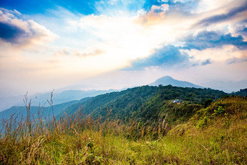 Fototapeta na wymiar Rrainforest mountain viewpoint of Sanknokwua (San Knok Wua) hill at Khao Laem National Park. The highest peak in Kanchanaburi photo during sunrise.