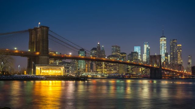 Panoramic view of Brooklyn bridge and Manhattan at sunrise, New York City. Time lapse of night to day transition.