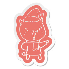 happy cartoon  sticker of a pig in winter clothes wearing santa hat