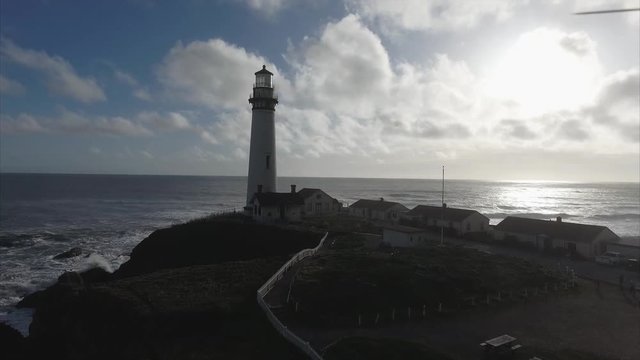Aerial shot  of the lighthouse on the coast in the pacific ocean, very cinematic