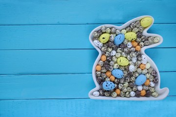 Fototapeta na wymiar Easter concept.Easter bunny decorative with Easter eggs on a wooden board background.Easter Flat lay. top view, copy space.Easter Flat lay. Spring Easter Mockup. 