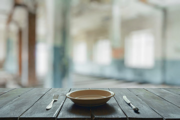 old wooden table in room with big windows