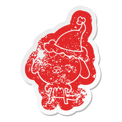 happy cartoon distressed sticker of a dog wearing santa hat