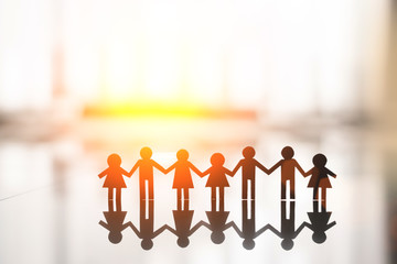 Human Shape in Paper cut With Hand by Hand or Shake Hand in National Friendship Day concept in flare light