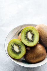 Green kiwi fruit on concrete background