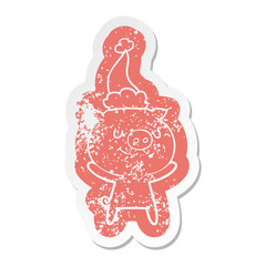 happy cartoon distressed sticker of a pig wearing santa hat
