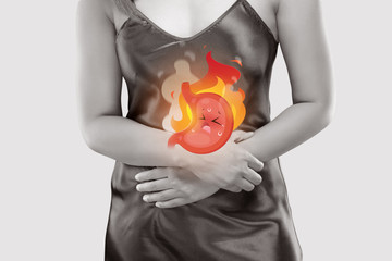 The photo of cartoon stomach on woman's body against a gray background, Gastroesophageal reflux disease, Acid reflux disease symptoms or heartburn, Concept with healthcare and medicine