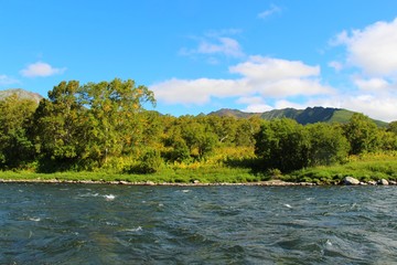 Beautiful Bystraya Malkinskaya river flows in valley between hills on the Kamchatka Peninsula, Russia.