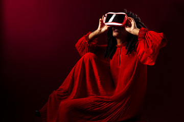 Portrait of a woman sitting and using a virtual reality headset