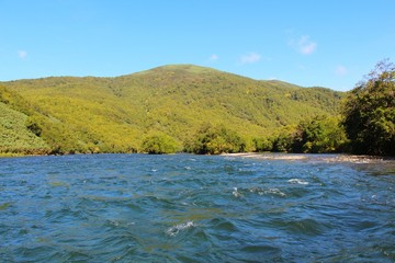 Beautiful Bystraya Malkinskaya river flows in valley between hills on the Kamchatka Peninsula, Russia.