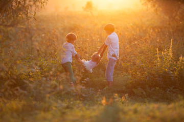 Fototapeta premium Portrait of pretty happy sister and brothers in suummer, outdoor