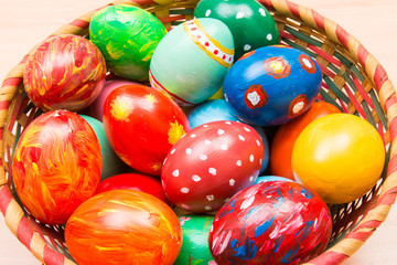 Fototapeta na wymiar Easter background with handmade colored eggs on nest. Top view. Festive tradition