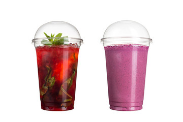 Delicious fruit smoothies in plastic cups, on a white background. Two cocktails with berry mojito flavor and wild berries.