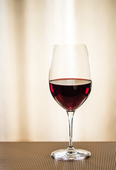 Single glass of red wine vertical