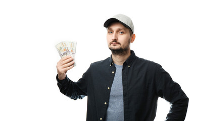 Bearded guy in cap holds money in his hands, is isolated on white background.