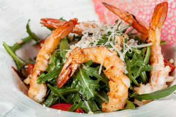 large and appetizing ready-made shrimps beautifully laid out with greens and vegetables for design solutions in cooking