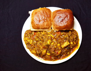 Pav bhaji a popular fast food dish of India, consisting of a thick vegetable curry, fried and served with a soft bread roll.