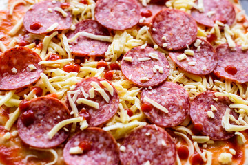 pepperoni pizza ready for baking, closeup