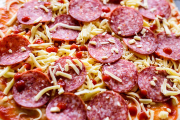 pepperoni pizza ready for baking, closeup