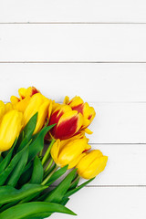 Spring tulips flower on wooden background.